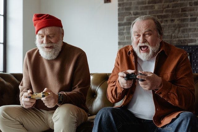 two older men playing videogames